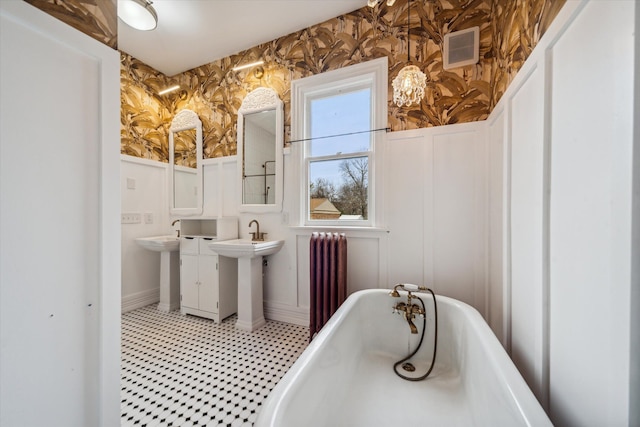 bathroom featuring radiator and a bath