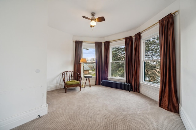 unfurnished room with radiator, light carpet, and a healthy amount of sunlight