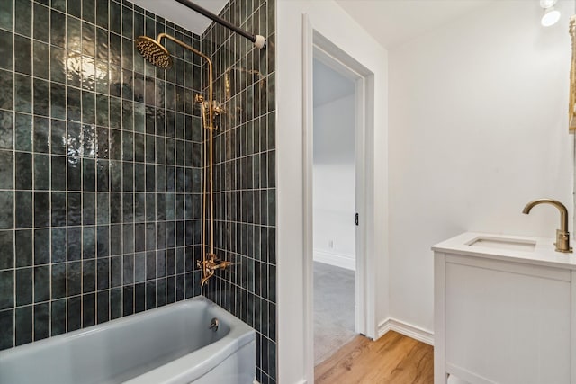 bathroom featuring vanity, tiled shower / bath combo, and hardwood / wood-style flooring