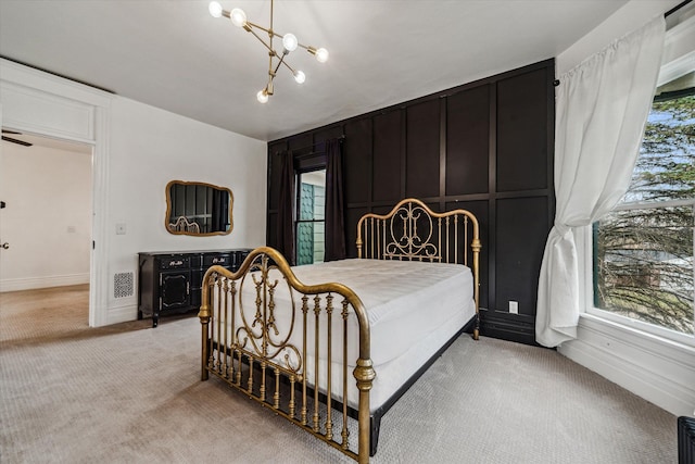 bedroom featuring a chandelier and light colored carpet