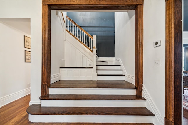 stairway with hardwood / wood-style flooring