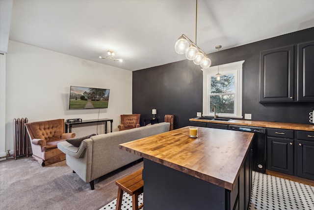 dining space with light colored carpet, radiator heating unit, and sink