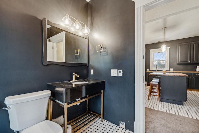 bathroom featuring sink and toilet