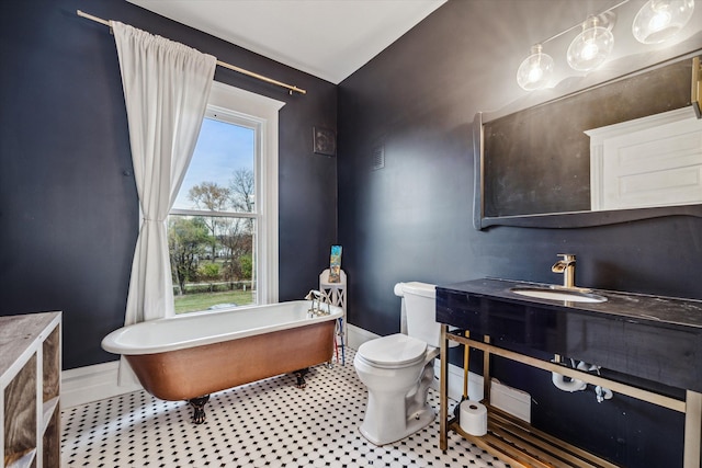 bathroom with a tub, sink, and toilet