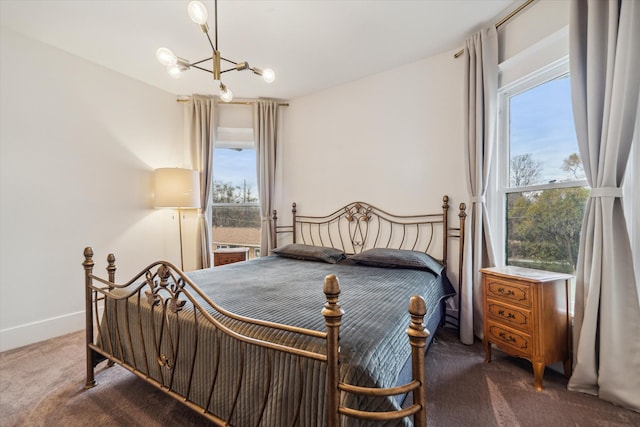 carpeted bedroom featuring a notable chandelier