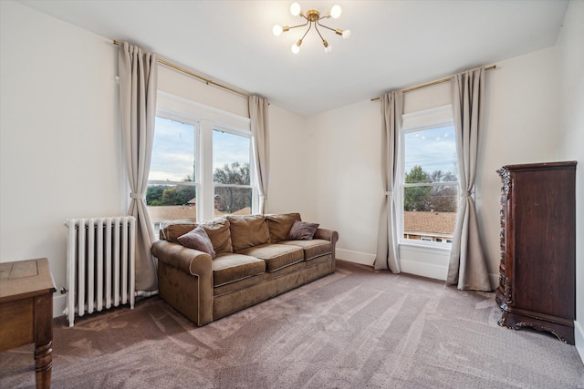 living room with carpet floors, radiator, and a chandelier