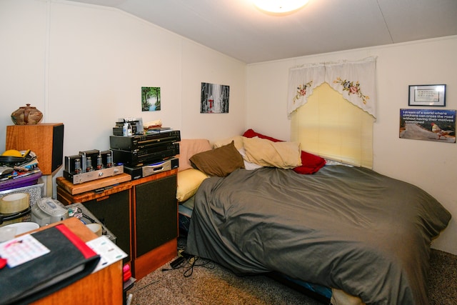 bedroom with carpet floors and lofted ceiling