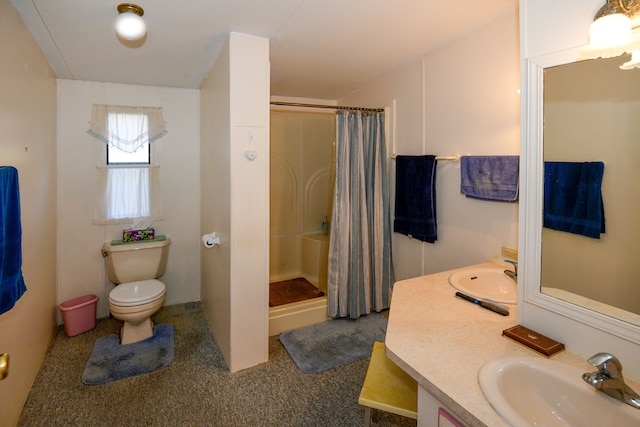 bathroom with vanity, curtained shower, and toilet