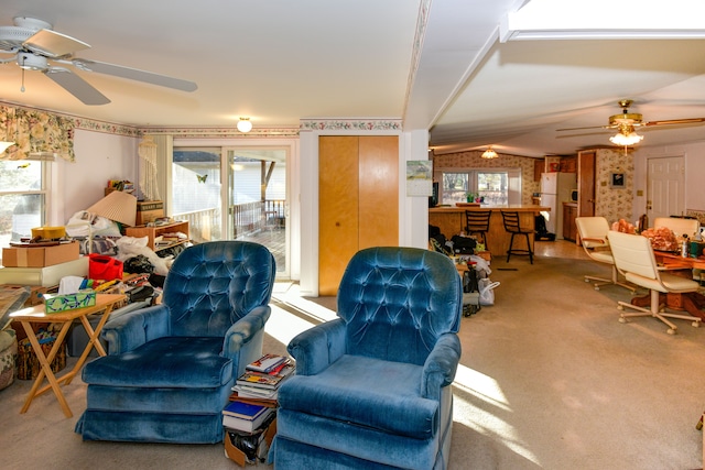 carpeted living room with vaulted ceiling and ceiling fan