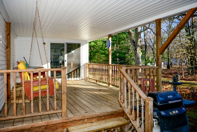 wooden terrace with a grill