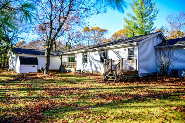 view of front of home with a shed and a front yard