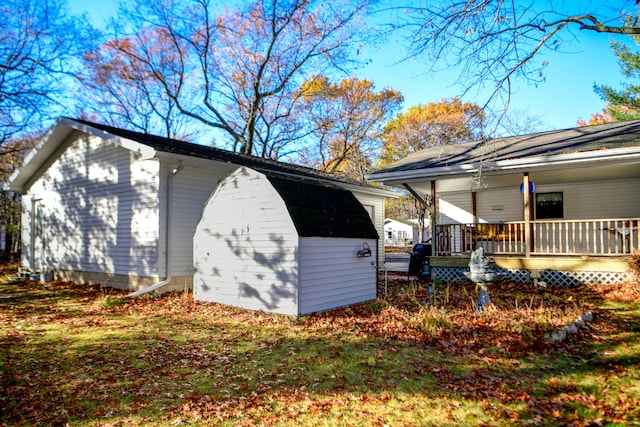 view of property exterior featuring a yard and a storage unit