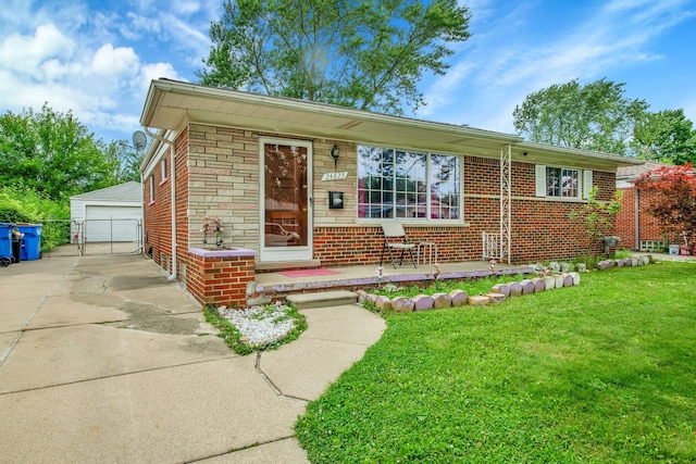 view of front of property featuring a garage, a front lawn, and an outdoor structure