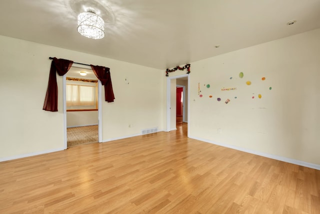 unfurnished room with light wood-type flooring