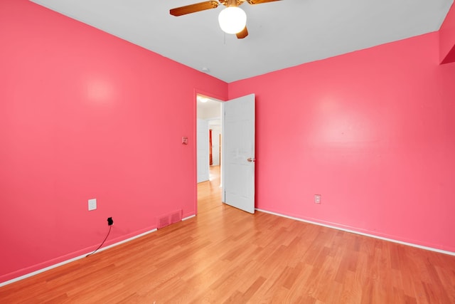 empty room with light hardwood / wood-style floors and ceiling fan