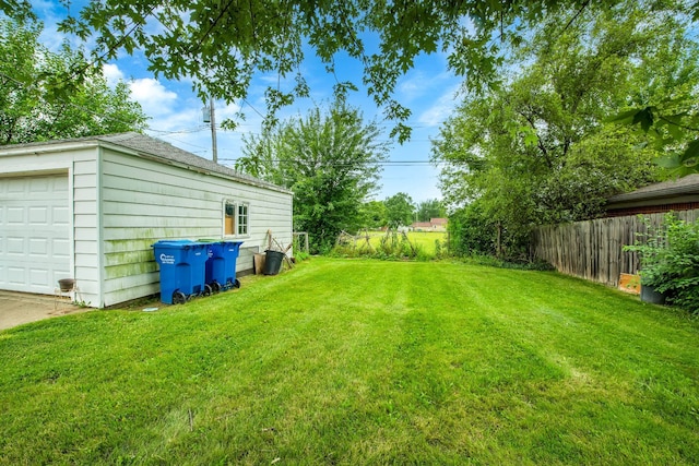 view of yard with a garage and an outdoor structure