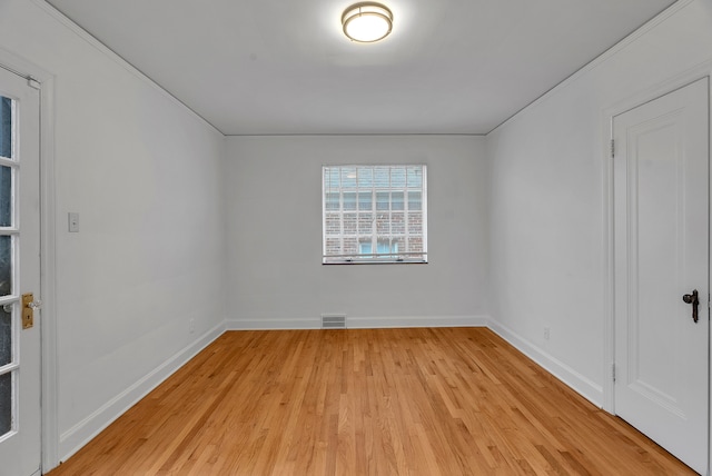 spare room with crown molding and light hardwood / wood-style floors