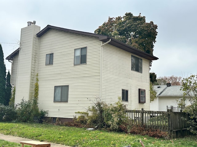 view of side of home featuring a lawn