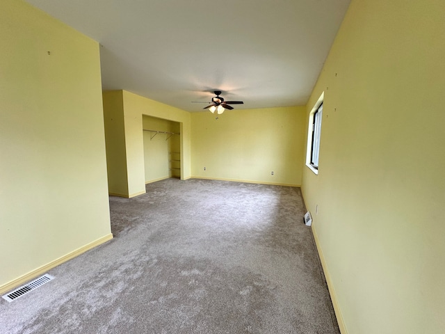 empty room with carpet flooring and ceiling fan