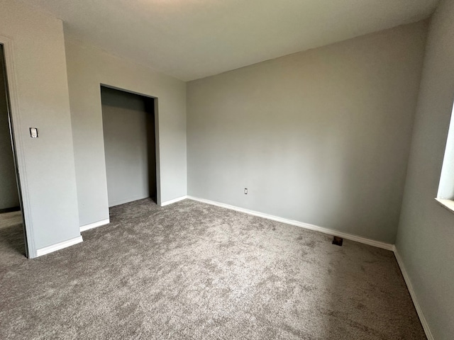 unfurnished bedroom featuring a closet and carpet floors