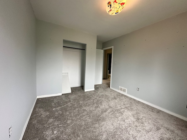 unfurnished bedroom with carpet floors and a closet