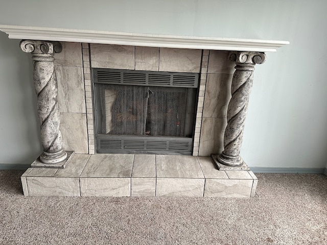 room details with a tiled fireplace and carpet