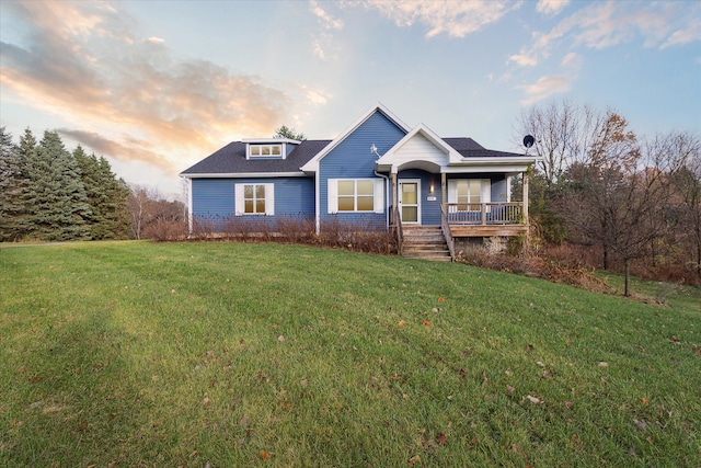 view of front of property featuring covered porch and a yard