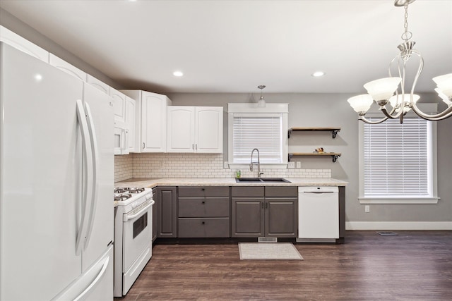 kitchen with white cabinets, dark hardwood / wood-style floors, white appliances, and sink