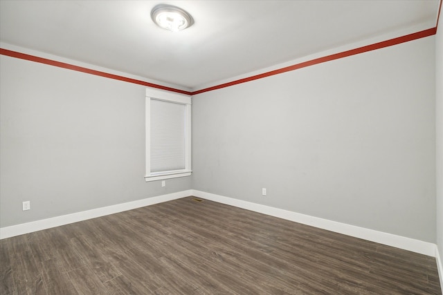 unfurnished room with dark hardwood / wood-style flooring