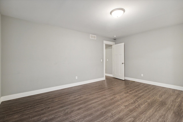 empty room featuring dark wood-type flooring