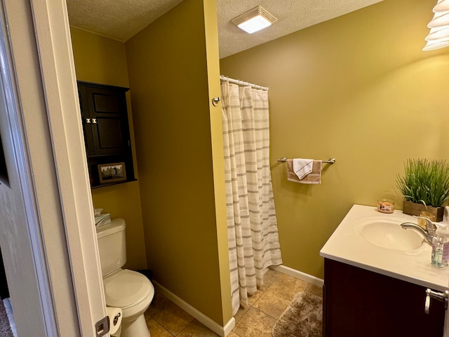 bathroom featuring tile patterned flooring, vanity, toilet, and a textured ceiling