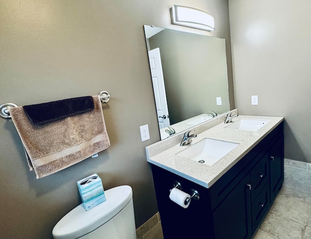 bathroom featuring tile patterned floors, vanity, and toilet