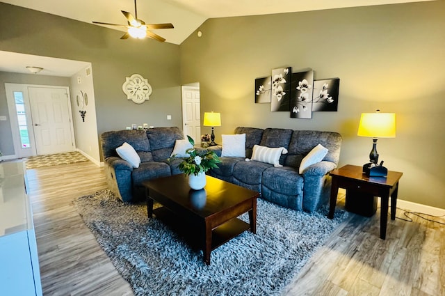 living room featuring ceiling fan, wood-type flooring, and high vaulted ceiling