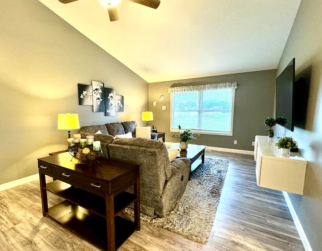 living room with hardwood / wood-style floors, vaulted ceiling, and ceiling fan