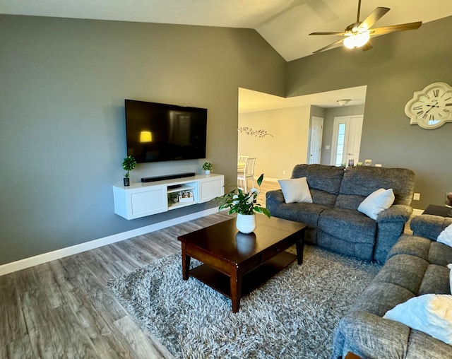 living room with hardwood / wood-style flooring, ceiling fan, and lofted ceiling