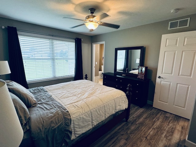 bedroom featuring a textured ceiling, dark hardwood / wood-style floors, and ceiling fan