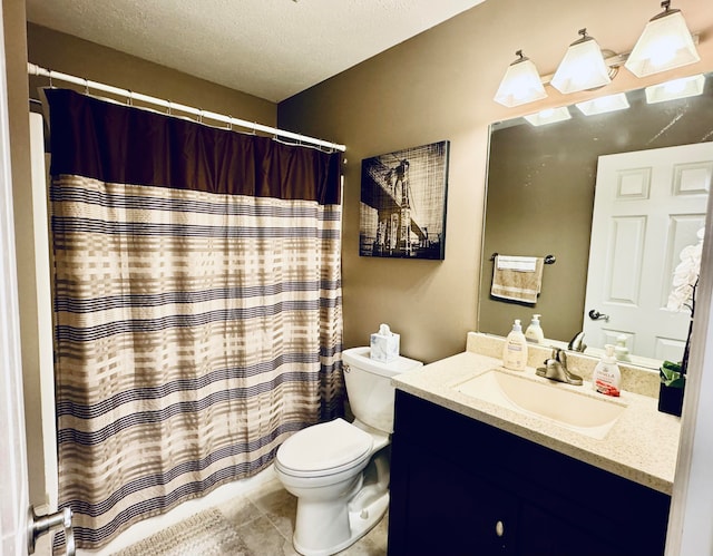 bathroom with tile patterned floors, vanity, a textured ceiling, and toilet