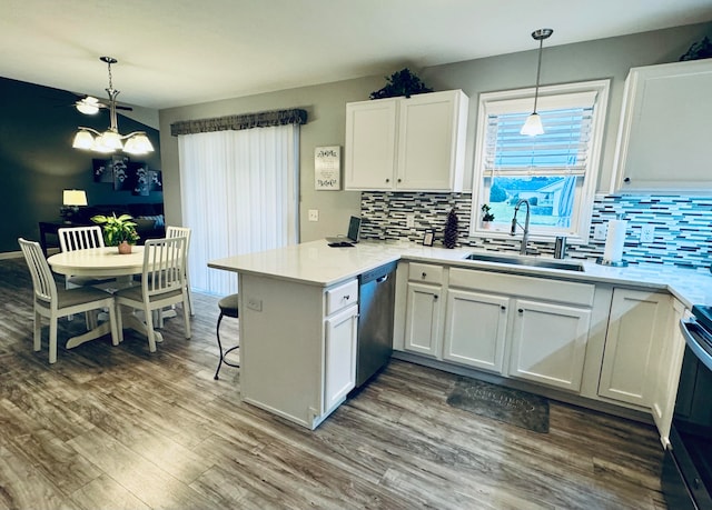 kitchen with white cabinets, decorative backsplash, pendant lighting, and kitchen peninsula