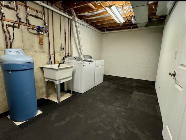 basement with sink and washer and dryer