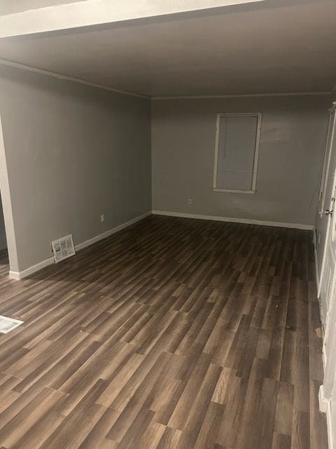 spare room with dark hardwood / wood-style flooring