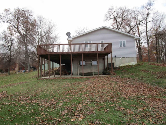 rear view of property with a yard and a wooden deck