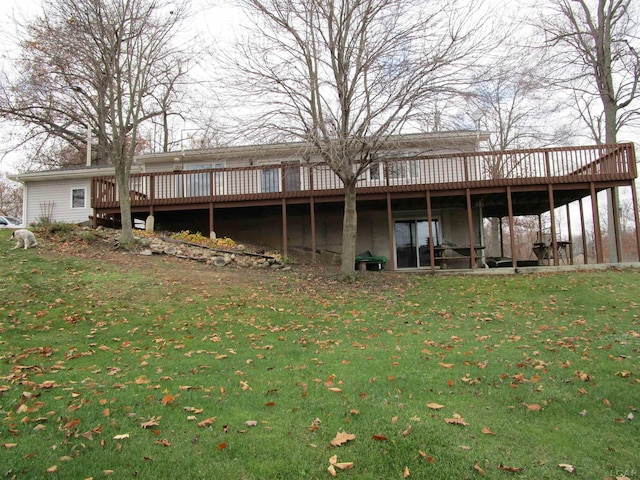 rear view of property with a yard and a wooden deck