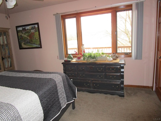 bedroom with ceiling fan and carpet floors