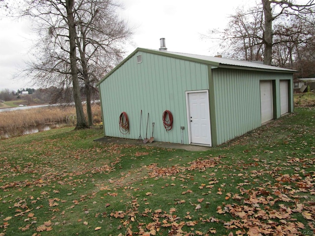 view of outbuilding with a garage and a yard