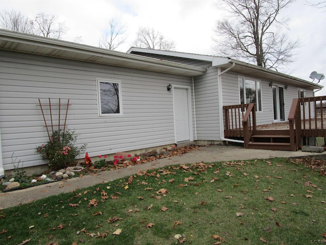 exterior space featuring a wooden deck and a yard