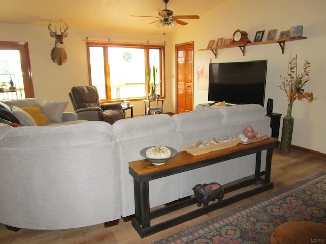 living room with ceiling fan, a healthy amount of sunlight, and wood-type flooring