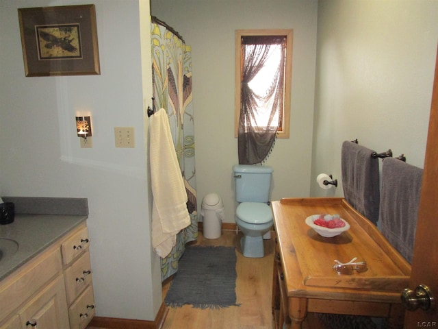 bathroom with hardwood / wood-style floors, vanity, and toilet