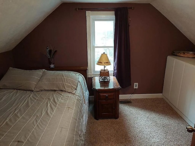 bedroom featuring light colored carpet and lofted ceiling