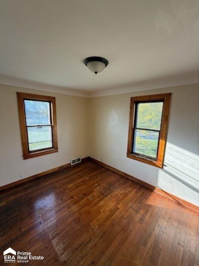 spare room featuring dark hardwood / wood-style floors