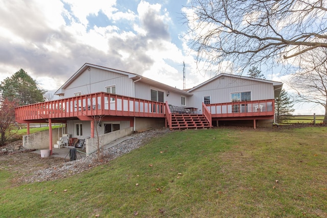 rear view of property featuring a patio area, a deck, and a yard